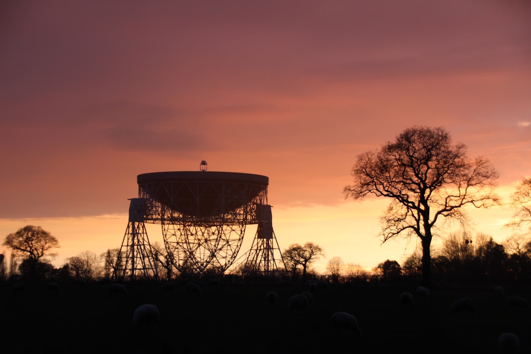 A radar dome against a darkening sky.