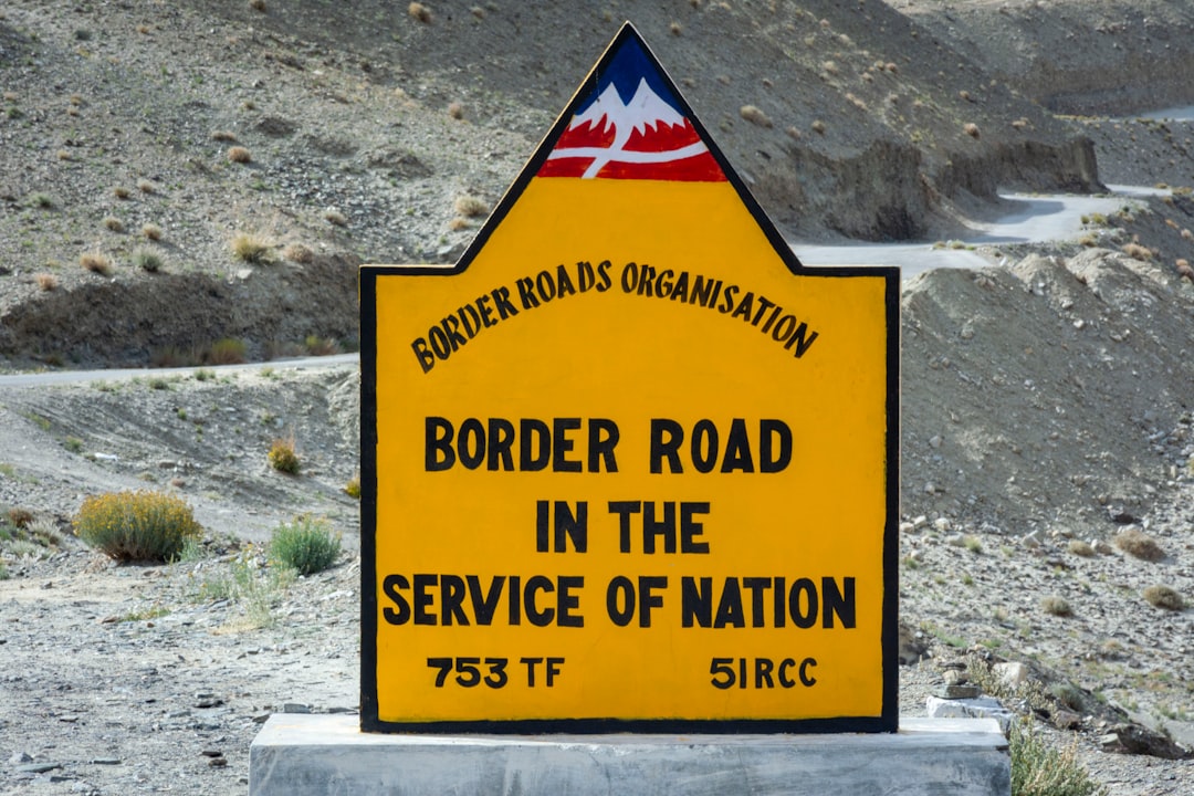 A rugged mountain landscape along a national border.