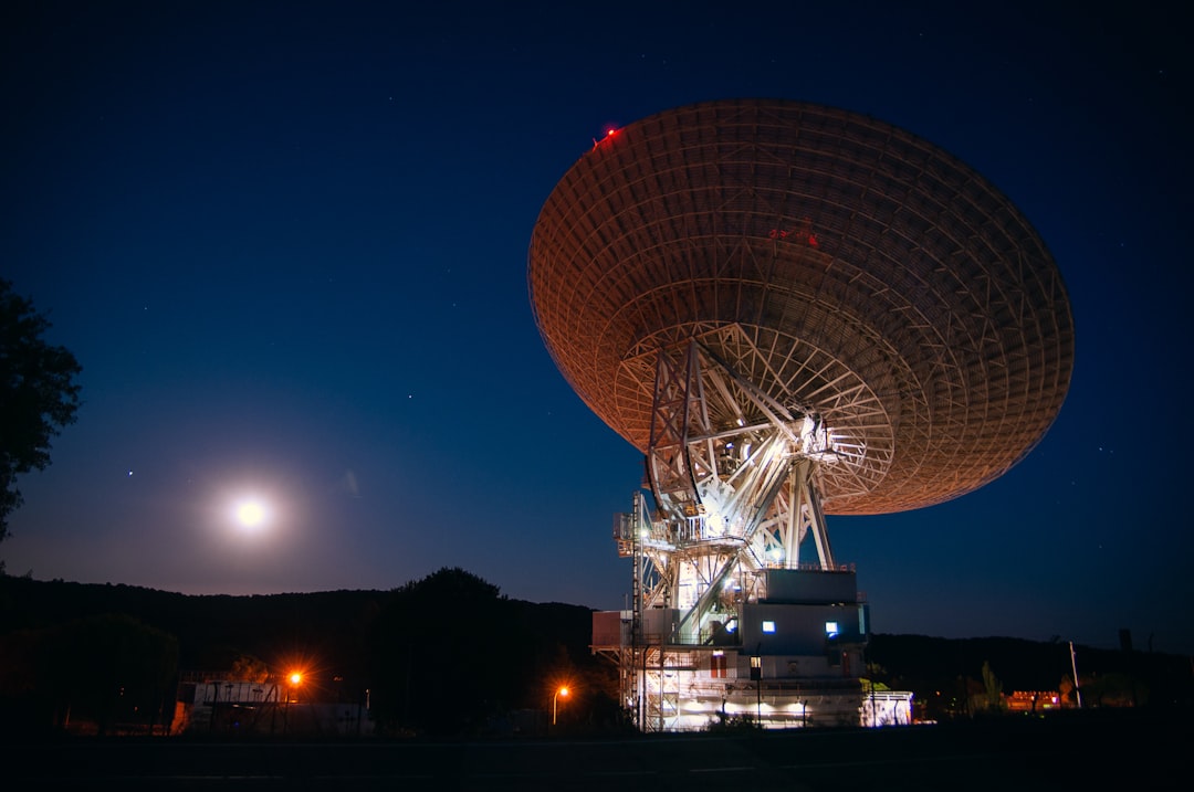 A remote military radar installation at dusk.