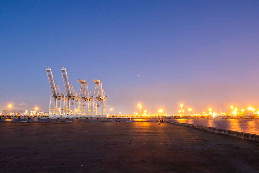 A commercial vessel sits idle at a darkened port.