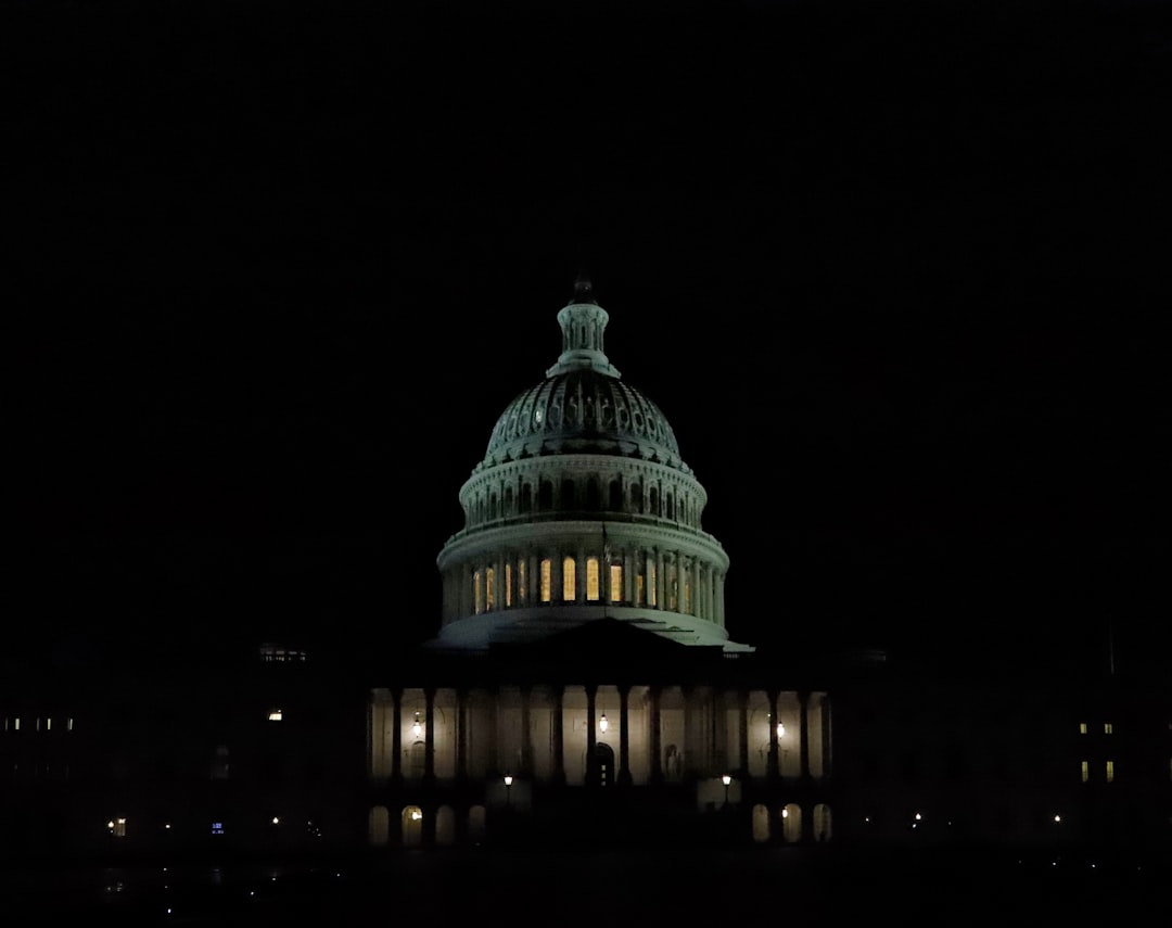 The US Capitol building illuminated at night.