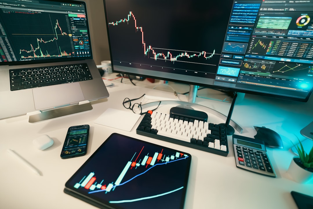 Stock market charts displayed on computer monitors.