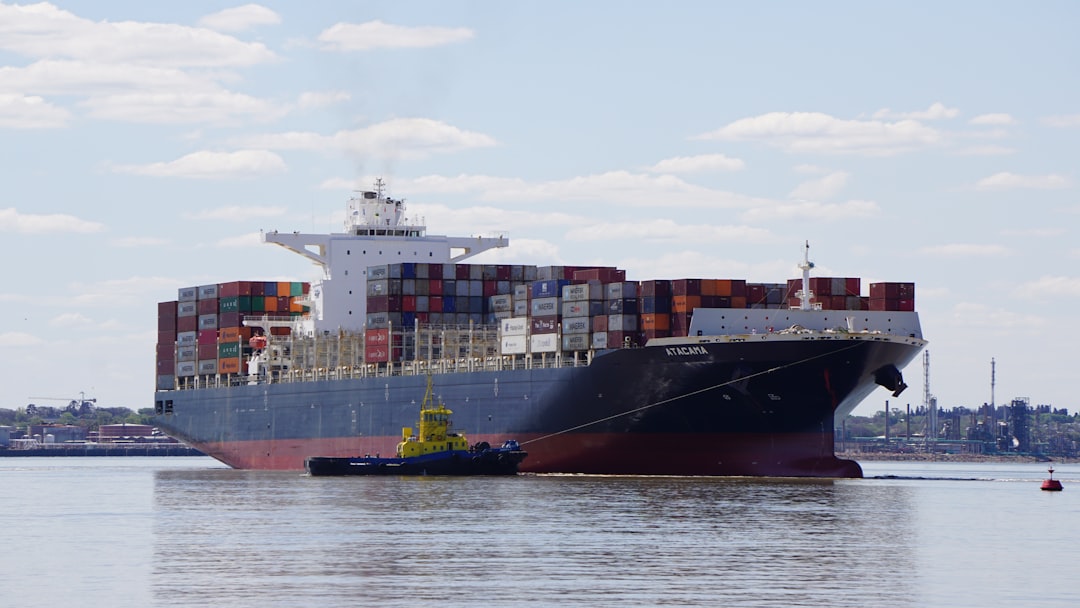 Commercial shipping vessels in open water.