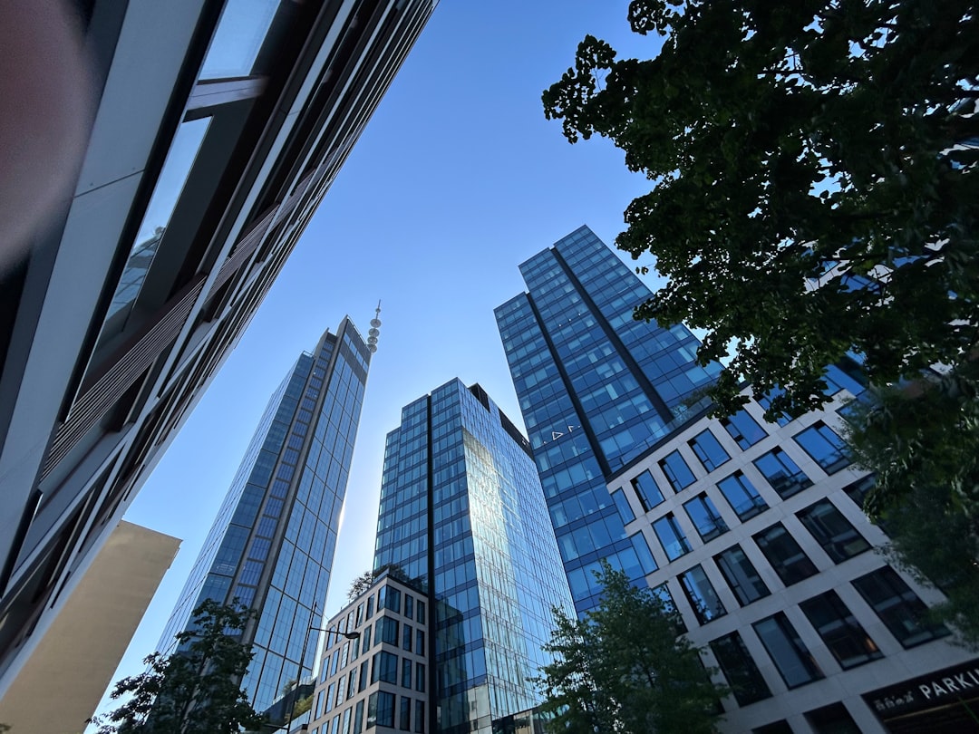 A modern glass office building representing corporate control.